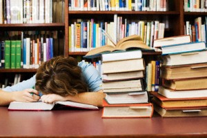 Exhausted Student Falling Asleep While Cramming --- Image by © Randy Faris/Corbis